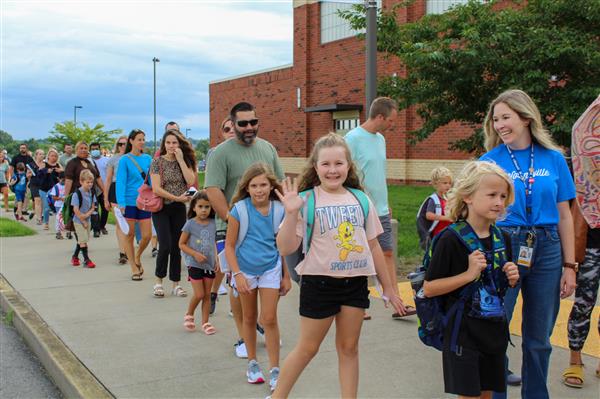 Students walking in on the first day of school. 